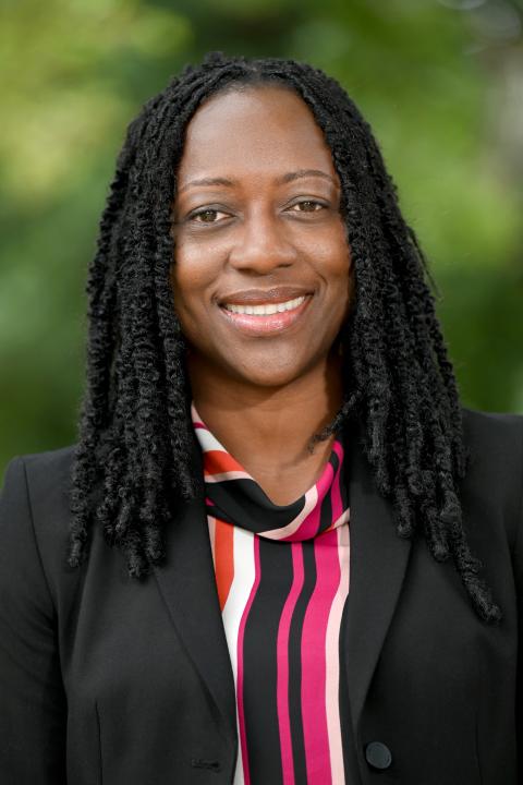 Profile photo of Leanora Brown wearing a black blazer and striped shirt