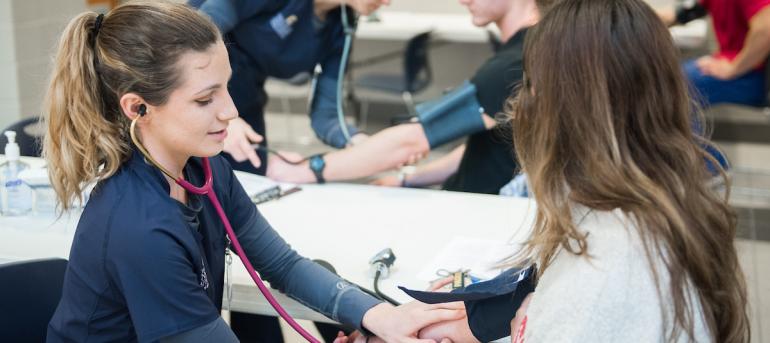 Nursing student takes blood pressure
