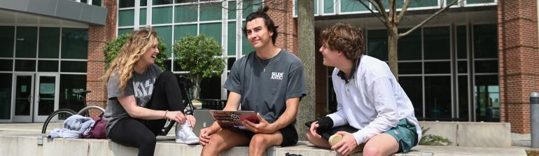 Three students outside the library