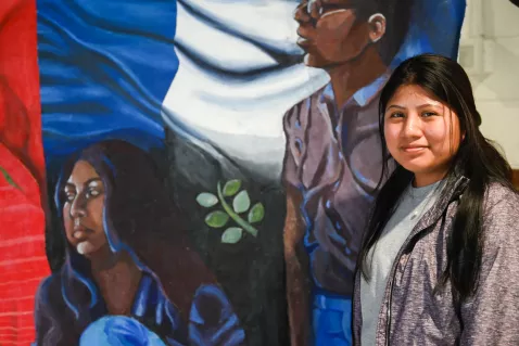 UTC Latin American Studies student in front of a mural